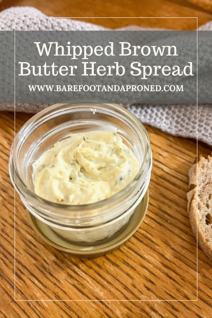 whipped brown butter spread in a mason jar on a table with a kitchen towel