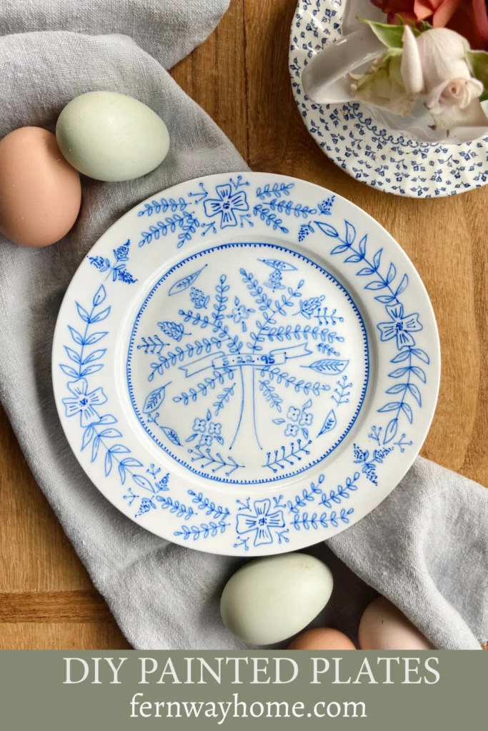 hand painted porcelain plate on a table with a tea towel and chicken eggs