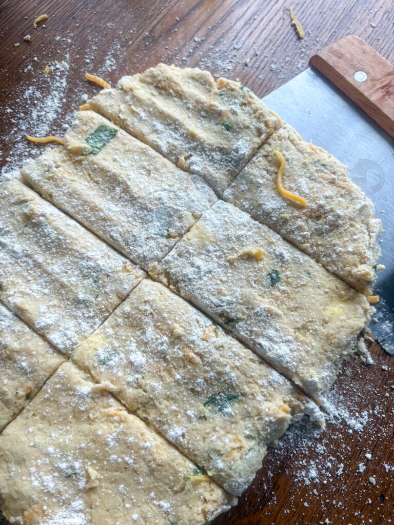 garlic cheddar biscuit dough with flour on a kitchen table